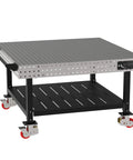 Hella Sturdy Heavy Duty Welding Fixture Table With Precision Laser Cut Industry Standard Holes And Locking Swivel Casters 60X60X36 view with shelf and handle