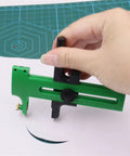 Hand using Double-Stage Adjustable Rotary Compass Circle Cutter for precise cutting on paper.