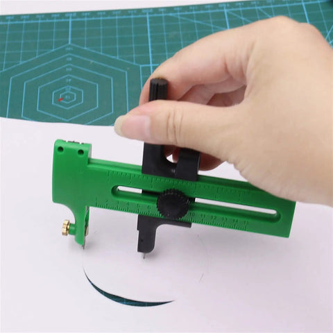 Hand using Double-Stage Adjustable Rotary Compass Circle Cutter for precise cutting on paper.