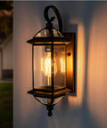 Solid Copper Outdoor Wall Light With Oil Rubbed Bronze Finish, 18.5 Inch Porch Lantern, Clear Beveled Glass, illuminated against wall