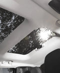Installed Kefly gray mesh headliner fabric with foam backing in car roof; sunroof glass visible.