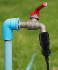 Drip Irrigation Faucet Adapter Kit With 25 PSI Pressure Regulator attached to outdoor faucet and hose