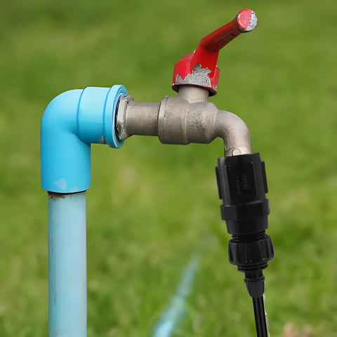 Drip Irrigation Faucet Adapter Kit With 25 PSI Pressure Regulator attached to outdoor faucet and hose