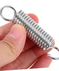 8 Piece Small Extension And Compression Springs With Hook Ends Made From Heavy Duty Stainless Steel For Electric Vehicle Supports And Ladder Feet Reliable Spring Kit That Handles Heavy Loads No Hassle close-up in hand