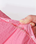 Close-up of Pink Bubble Mailers 100 Pack 12x18 And 4 Inch Thickened Self Sealing Shipping Envelopes showing bubble lining and tear resistance.