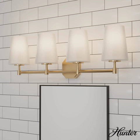 Nolita Vanity Light With Alturas Gold Finish And Cased White Glass against tiled wall, modern medium size bathroom fixture