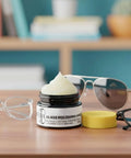 Scratch Remover Kit For Glasses And Screens Polishing Paste on table with eyeglasses and sunglasses nearby.