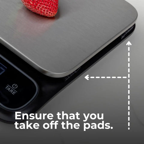 Beast Mode Precise Waterproof Digital Kitchen Scale With 0.1g Accuracy, 11lb Capacity showing tare button and stainless platform with strawberry