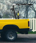 Built Tough Heavy Duty Folding Engine Hoist And Pickup Bed Tailgate Crane With Slick Hydraulic Winch on yellow truck bed.