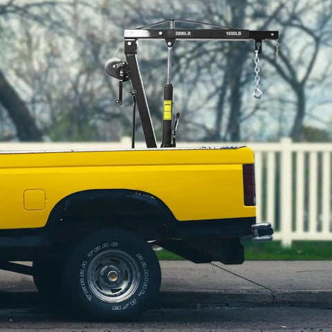 Built Tough Heavy Duty Folding Engine Hoist And Pickup Bed Tailgate Crane With Slick Hydraulic Winch on yellow truck bed.