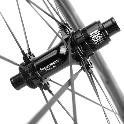Close-up of the Superteam ceramic hub with spokes on the Carbon Disc Wheelset S All D28 50 Tubeless With Carbon Spokes 700C For Shimano Road Bikes.