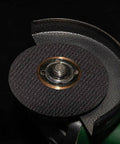 Cutting disc from Six Piece Cut Off Wheel Set With One Quarter Inch Stem For Die Grinder, mounted on tool, black reinforced with fiberglass