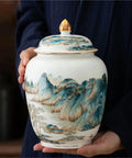 Top Shelf Premium Ceramic Airtight Tea Canister For Loose Leaf And Roasted Coffee Storage With Classic Chinese Landscape Motif, held in hands.