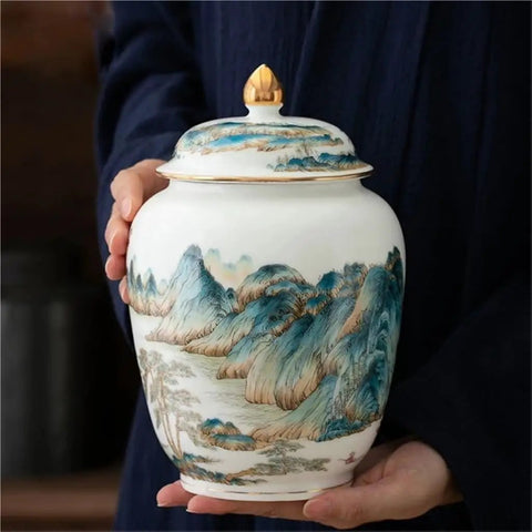 Top Shelf Premium Ceramic Airtight Tea Canister For Loose Leaf And Roasted Coffee Storage With Classic Chinese Landscape Motif, held in hands.