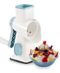 Manual Ice Shaver With 16 Stainless Steel Blades, blue and white, with a bowl of shaved ice topped with fruit and syrup.