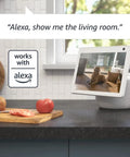 Smooth Swiveling Indoor Security Camera Locks Down Your Space With Crisp HD Video And Infrared Night Vision For Seamless Pan Tilt Coverage Plus Quick Plug And Play Two Way Audio Alexa Ready White mounted on kitchen counter with dog.