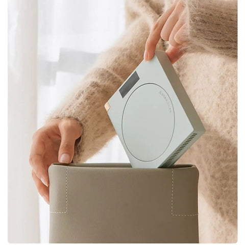 Ultra Smooth Electric Coffee Mug Warmer Usb Powered Cup Heater With Five Level Temp Control Auto Shut Off Compact Base being placed in a bag.