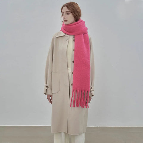 Woman wearing Cozy Large Blanket Wrap Shawl For Women, Soft Thick Knit Scarf Neck Warmer in pink, standing indoors.