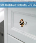 2 Pack 1.1 Inch Round Currency Coin Cabinet Knobs In Stainless Steel on a white kitchen drawer