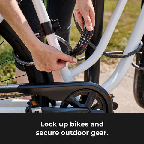 Person securing bike with Bike Cable Lock 6 Feet By Half Inch With Resettable Four Digit Combination and Black Vinyl Coating.