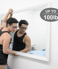 Man installing large mirror on wall with Heavy Duty Picture Hanging Kit For Walls Handles Up To 100 Lbs With Tough As Nails Wire