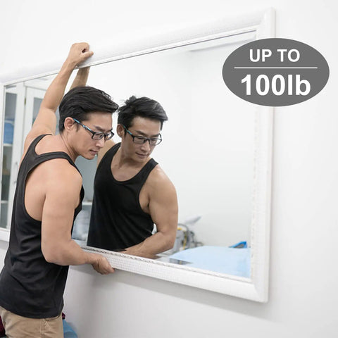 Man installing large mirror on wall with Heavy Duty Picture Hanging Kit For Walls Handles Up To 100 Lbs With Tough As Nails Wire