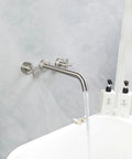 Wall Mounted Tub Filler Faucet With Two Handles, Brushed Nickel Finish, Extra Long 13 Inch Spout, Brass Rough In Valve shown filling tub
