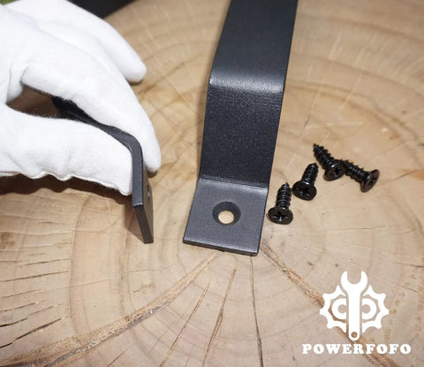 Heavy Duty Solid Steel Barn Door Handle And Closet Pull In Matte Black Powder Coat with screws, close-up view on wooden surface