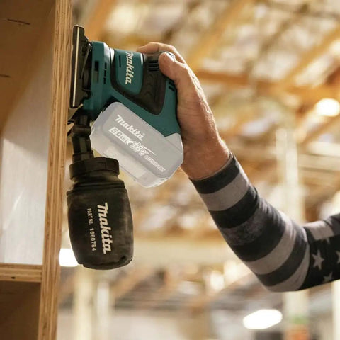 18V Cordless 1/4 Sheet Finishing Sander with Two Speed Control 11K and 14K OPM being used on wood cabinet