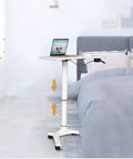 Rock Solid Rolling Laptop Cart With Height Adjustable Standing Desk and Smooth Glide Wheels For Bed Sofa Gaming Or Home Office Flex Setup next to bed.
