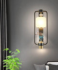 Slick Contemporary Wall Sconce With A Heavy Duty Black Iron Bracket And Clear Glass Shade For Pure Indoor Outdoor Vibes Perfect For Hallways And Bedrooms With Zero Glare And Hassle Free Setup on a gray wall.