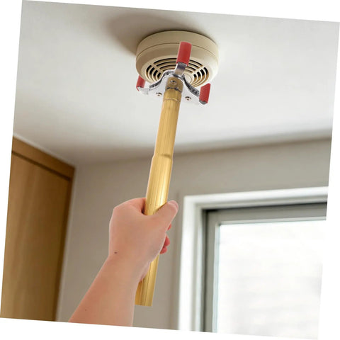 Hand using Slick Aluminum Alloy Ceiling Smoke Detector Puller With Heavy Duty Claw Head on a ceiling smoke detector.