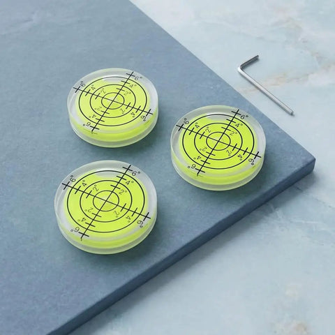 SILENRADAWN Small Circular Bubble Levels 3 Piece Round Spirit Level Layout on gray surface with clear yellow liquid.