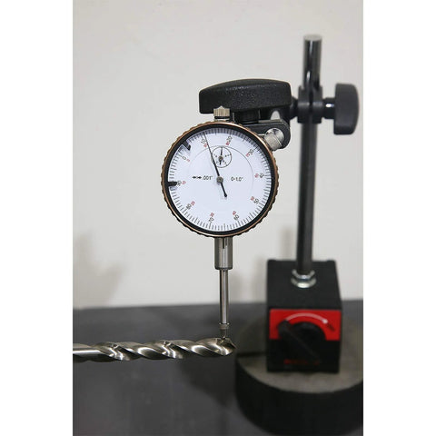 Dial indicator with magnetic base; white dial, brass bezel, 0-1.0 in range on adjustable stand.