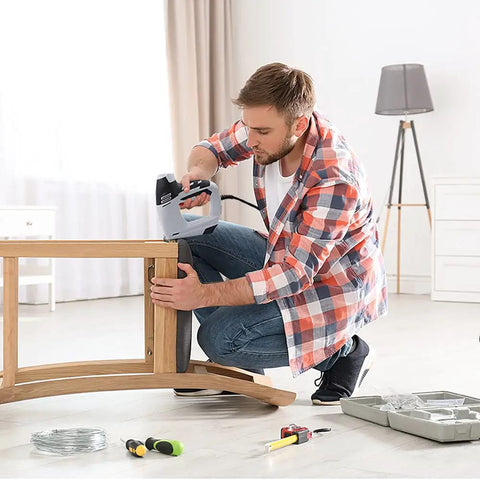Man using 4 In 1 Electric Staple And Brad Nailer Gun, 120V Power Hand Stapler for woodworking, lightweight ergonomic design