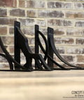 Miller Powder Coated Black Two Piece Millwork Kit One And A Half Inch Wide By Ten Inch Deep By Twelve Inch High Cabinet Trim against brick wall
