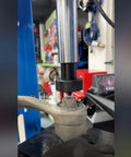 35Pcs Bushing Press Kit For Hydraulic Shop Press in use removing a bearing from a car suspension component.