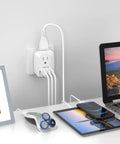 Go-To 6 In 1 Europe Travel Plug Adapter With 2 US Outlets, 3 USB Ports And USB-C connected to multiple devices on desk