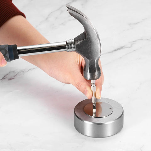 Steel bench block with hammer and punch shown; round silver base, no holes.