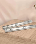 16 Inch Heavy Duty Soft Close Drawer Slides With Full Extension Ball Bearing Runners, Side Mount, Zinc Plated Steel, 100 Lb Capacity displayed on a wooden surface.