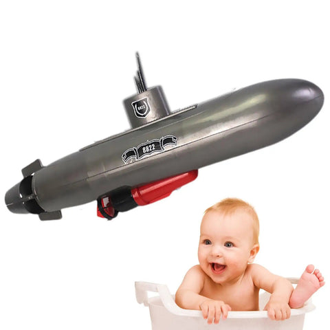 Mini RC Submarine Toy For Bath Time And Pool Play, Realistic Sub Design With Propeller Accessories next to a smiling baby