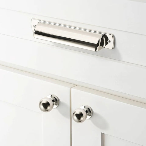 Front view of polished nickel cup pull installed on white cabinet, part of 10 Pack 2-1/2 Inch Polished Nickel Drawer Pulls Cabinet Cup Pulls Kitchen Hardware