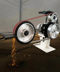 Badass 2X72 Inch Variable Speed Belt Sander And Multi Angle Vertical Horizontal Grinder For Knife Polishing With Three Abrasive Wheels And Rock Solid Base 110V 2840 RPM Shop Staple with sparks flying during grinding.