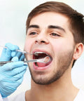 Dentist using LED Lighted Stainless Steel Mouth Mirror For Teeth Inspection And Plaque Removal during a dental exam.