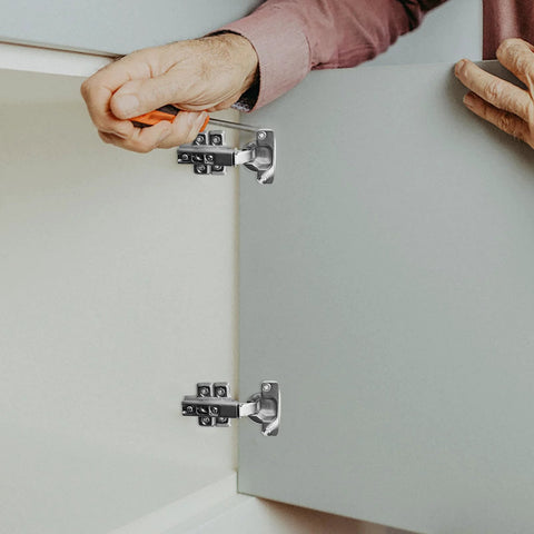heavy duty cabinet door hinges being installed on white cupboard