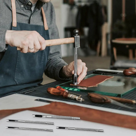 Craftsman using Six Piece Beefy Metal Hollow Hole Punch Kit for leather with tools visible, designed for DIY belt and wallet making