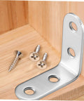 Close-up of Stainless Steel L Brackets With Screws Set For Raised Garden Beds And Furniture Frames next to a wooden surface