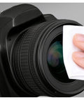Ordilend camera lens cleaning kit; close-up of lens being wiped with a white microfiber cloth