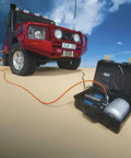Heavy Duty Road Trip Ready 12 Volt Twin Motor Portable Air Compressor with aluminum tank used for off-road tire inflation.