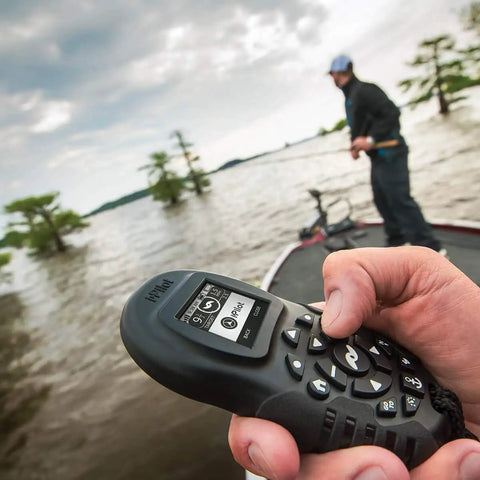 Hand holding Extra Bluetooth I Pilot System Remote For Trolling Motors Second Handheld Controller with LCD screen on a boat